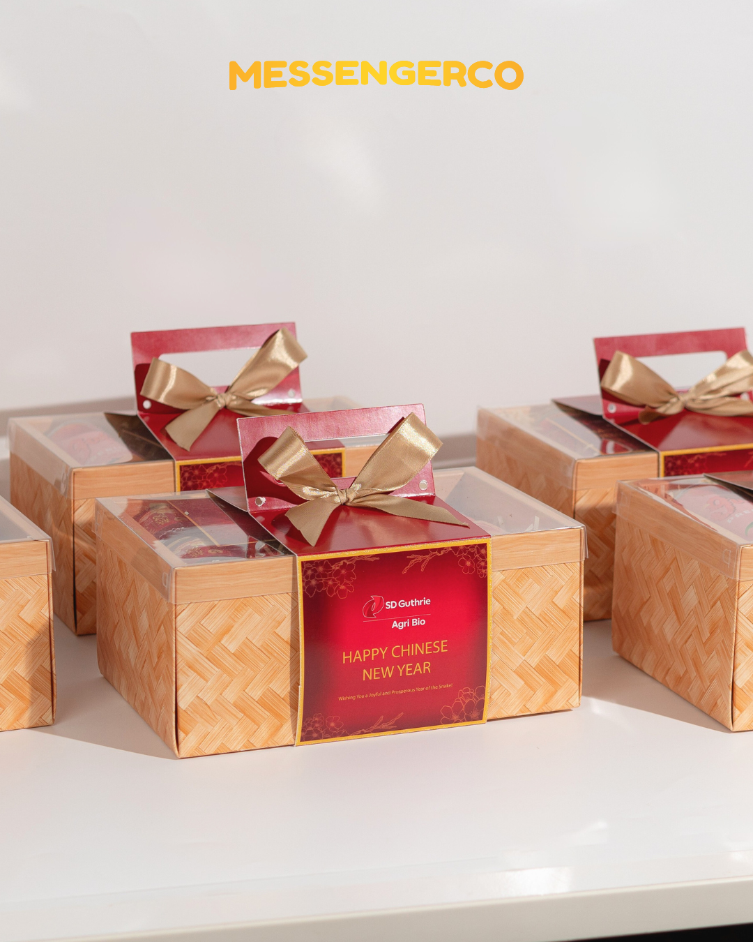 Messengerco Radiant Treasure CNY gift boxes for SD Guthrie; bamboo baskets with clear lids and red tops with golden bows.