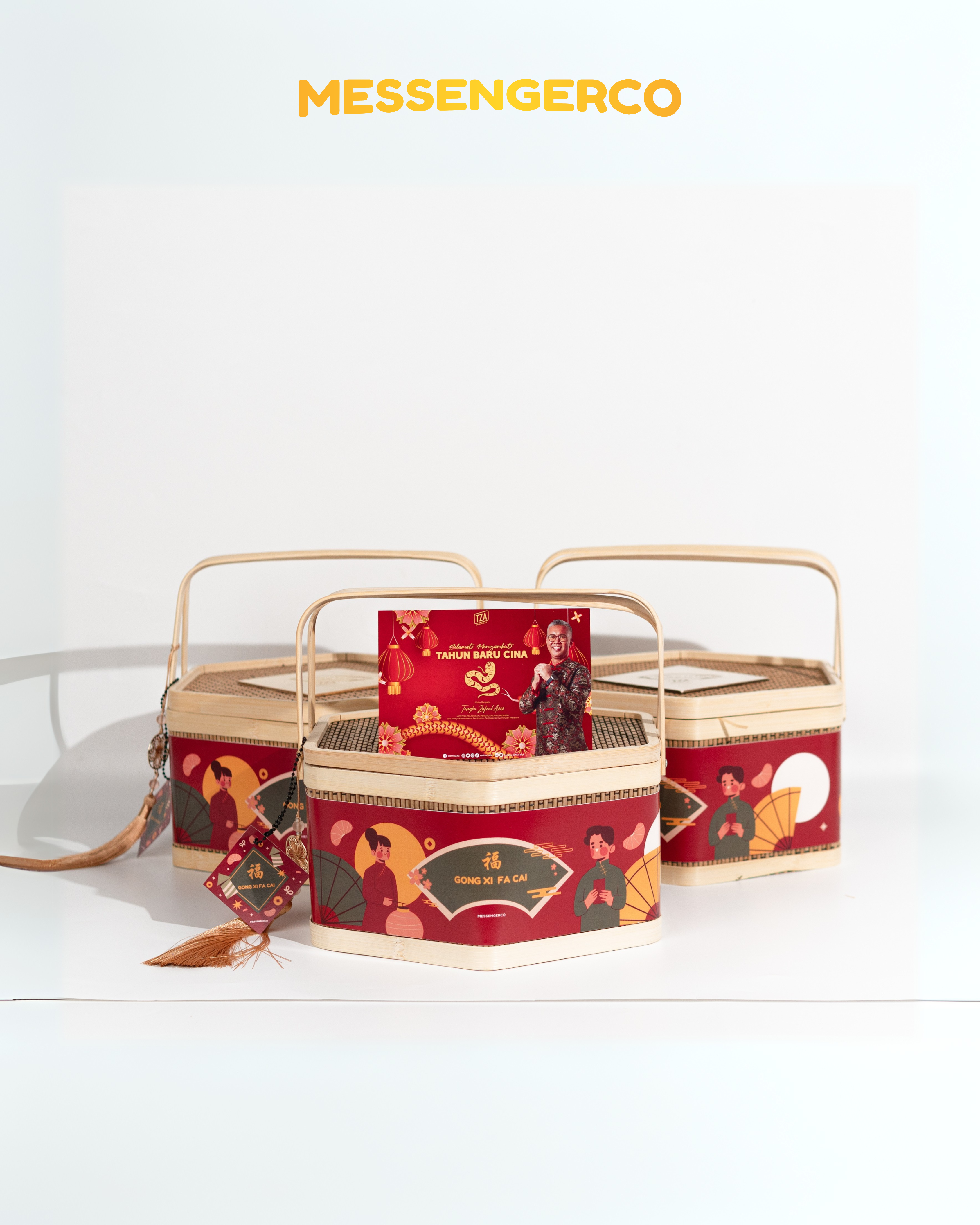 Three bamboo-handled Chinese New Year gift baskets with red ‘Gong Xi Fa Cai’ bands and a featured card in the centre.