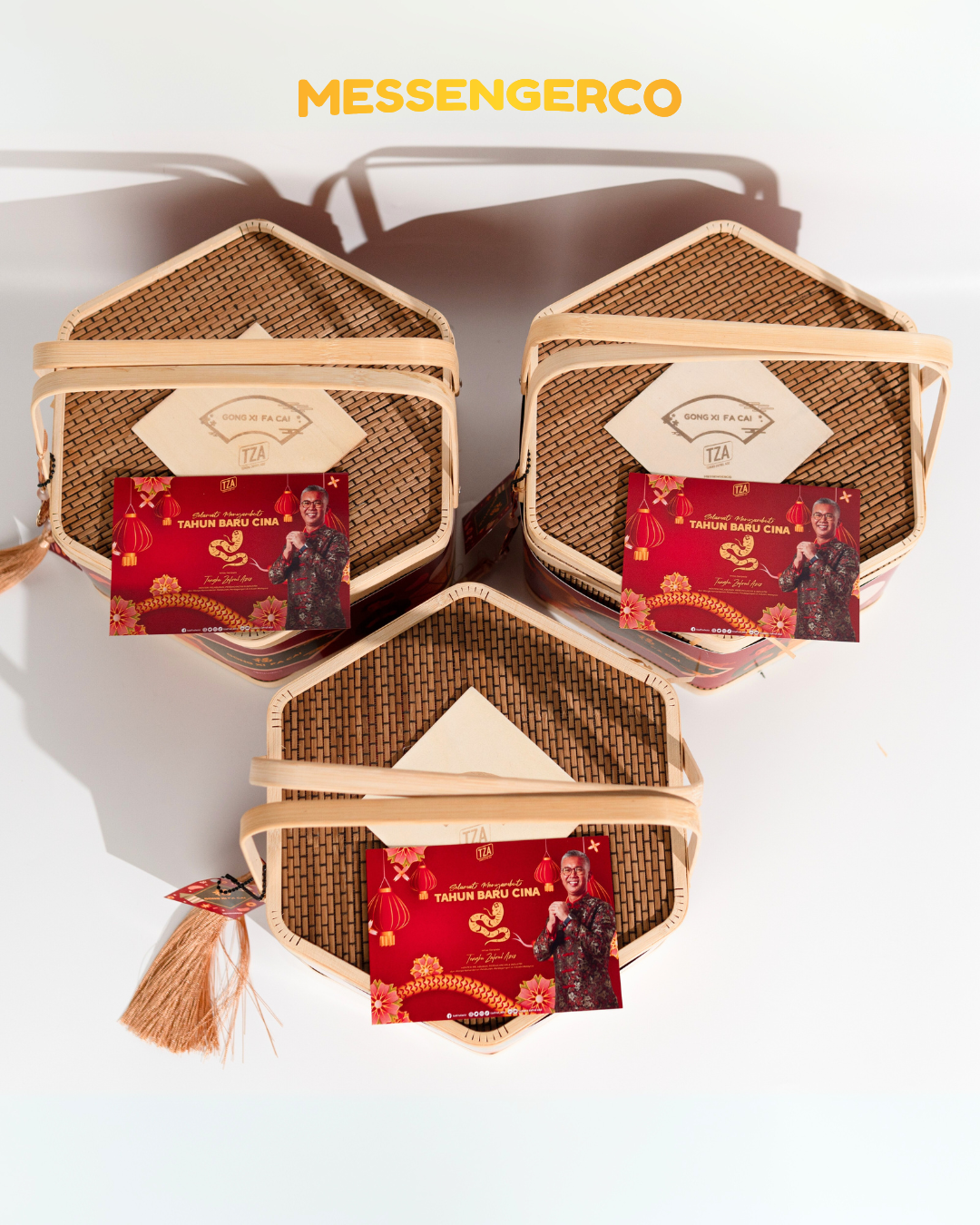 Top-down view of hexagonal bamboo CNY gift baskets each with a red greeting card and tassel detail on white surface.