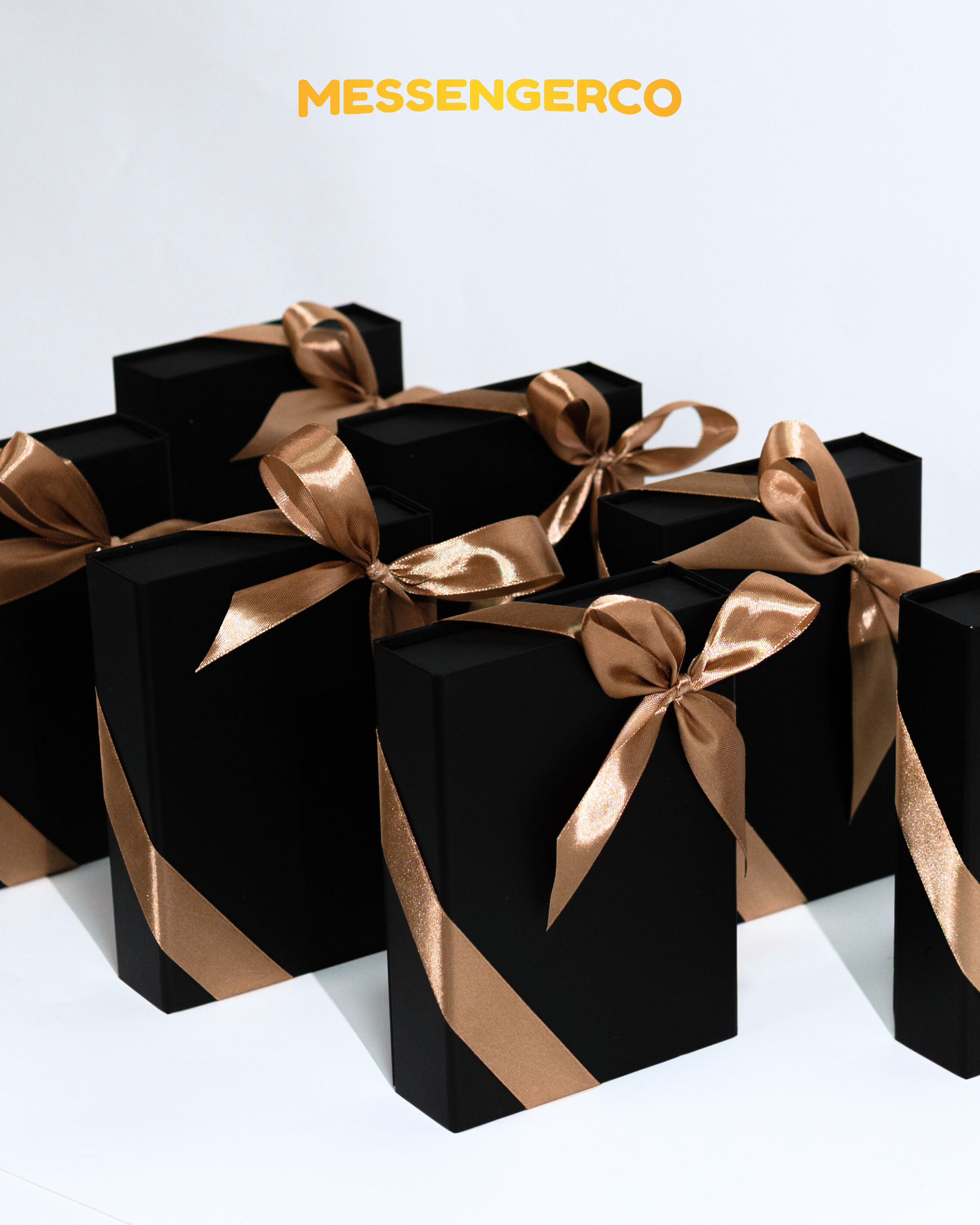 premium matte black appreciation gift boxes with gold ribbons by messengerco, stacked for graduation or corporate gifting