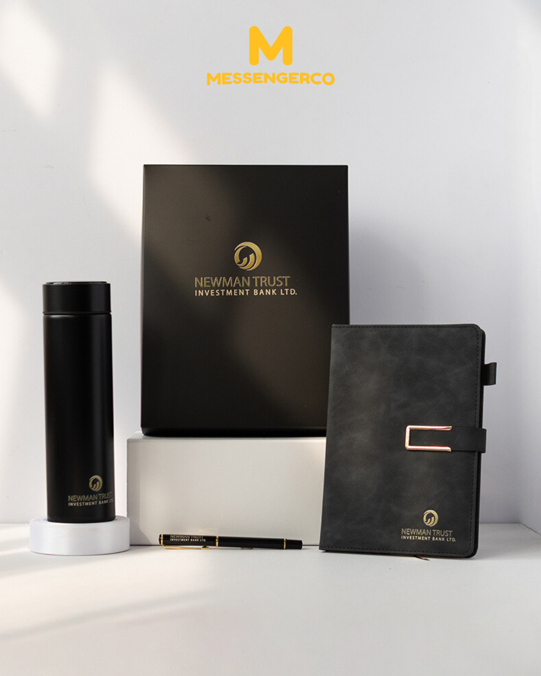 black corporate appreciation gift set featuring flask, suede notebook, and pen for newman trust investment bank