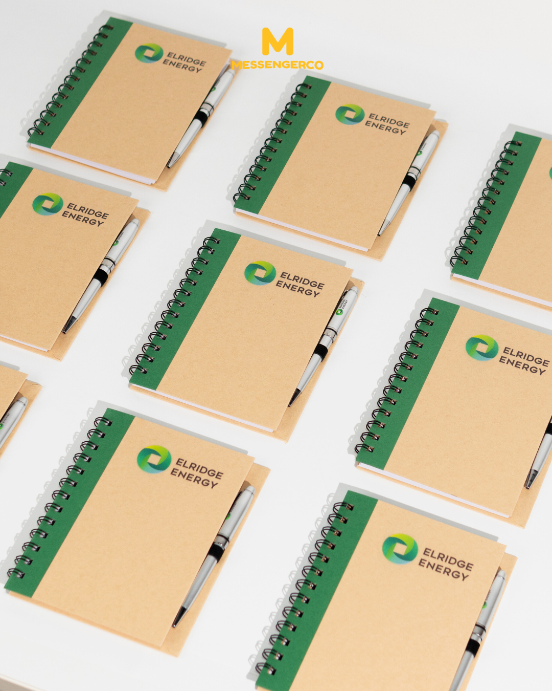 green eco notepads with pens customised with elridge energy logo arranged for event giveaways