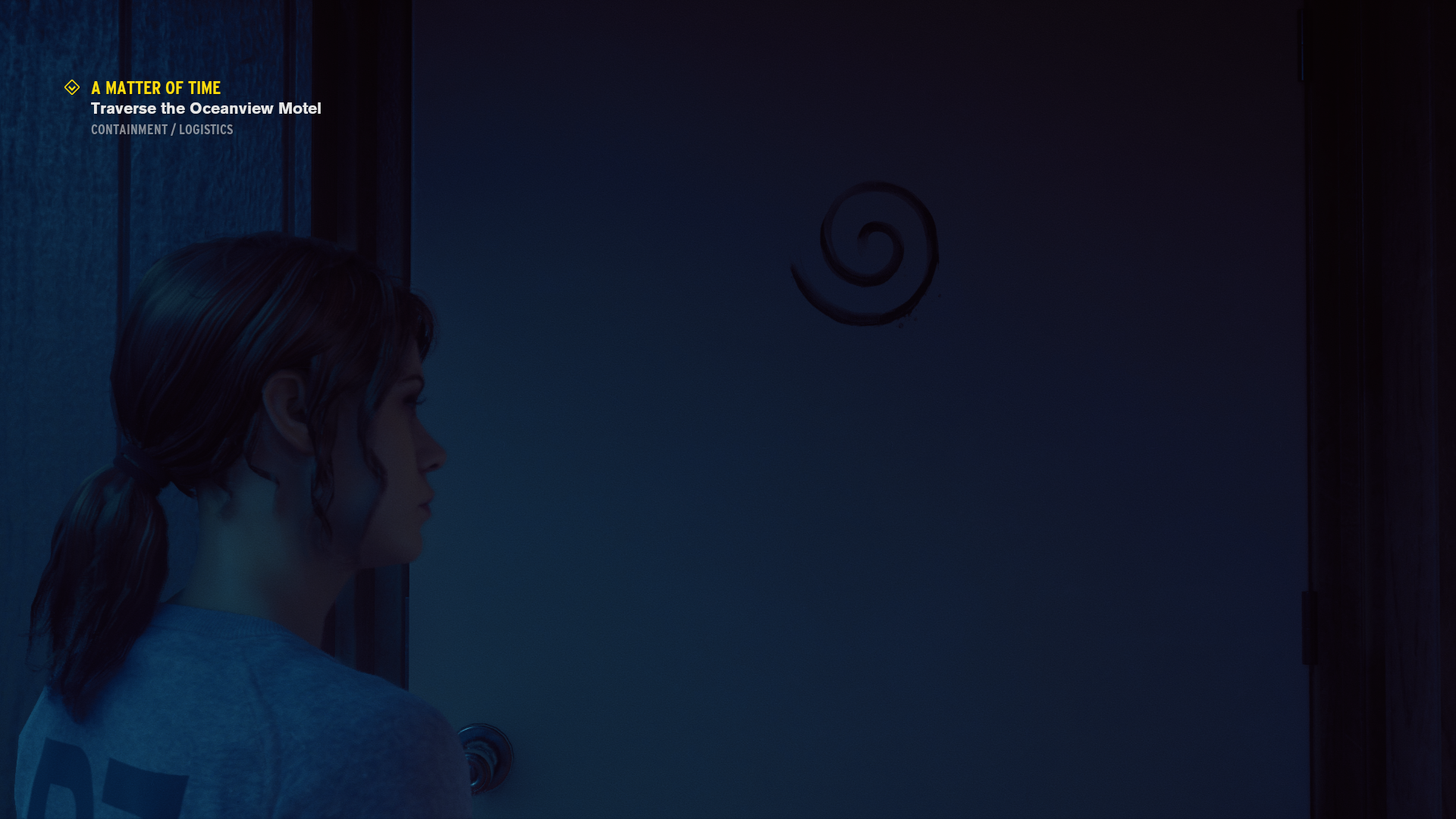 A screenshot of the video game Control showing a door with a spiral icon on it.