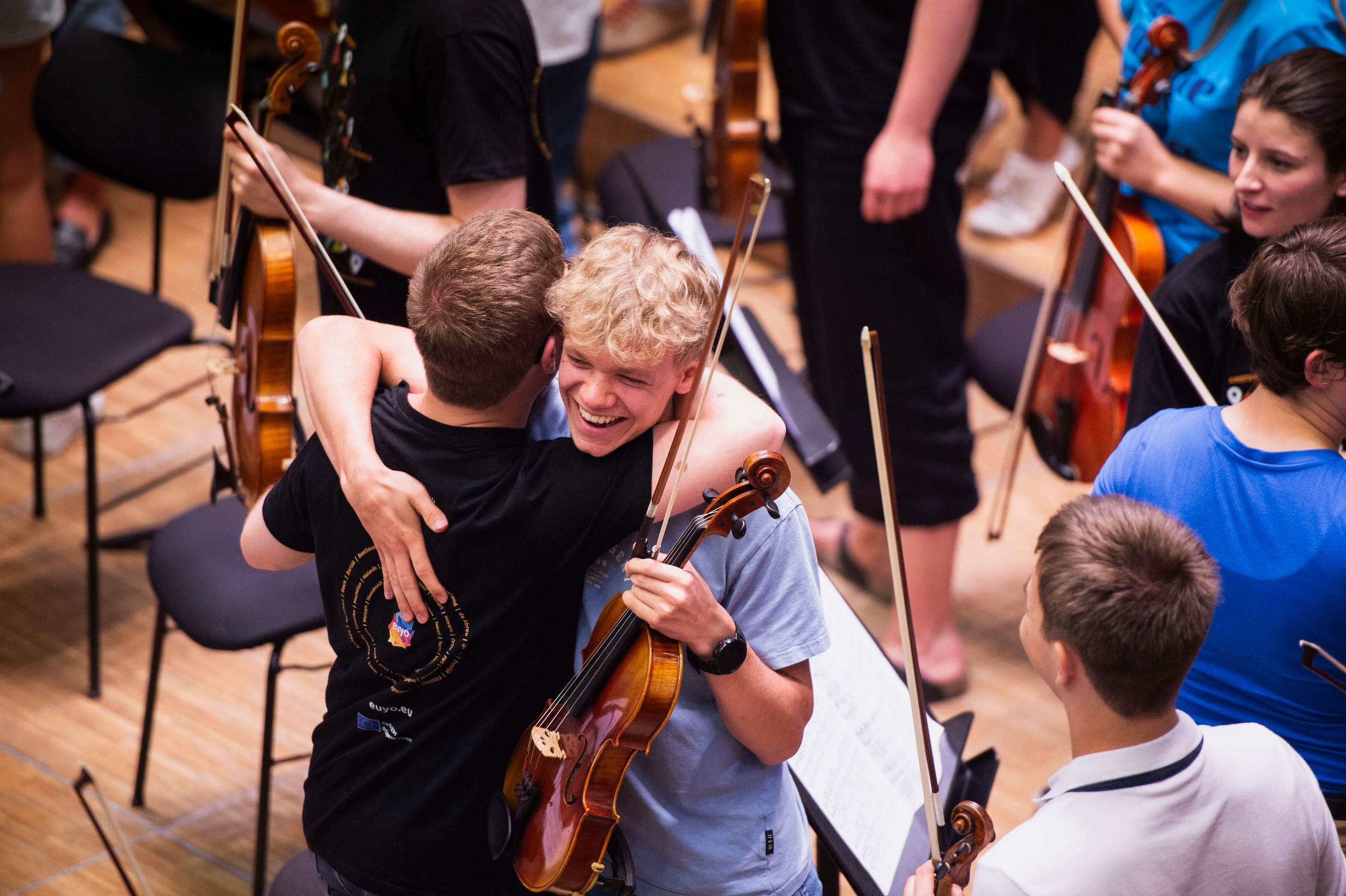 Musicians hugging.