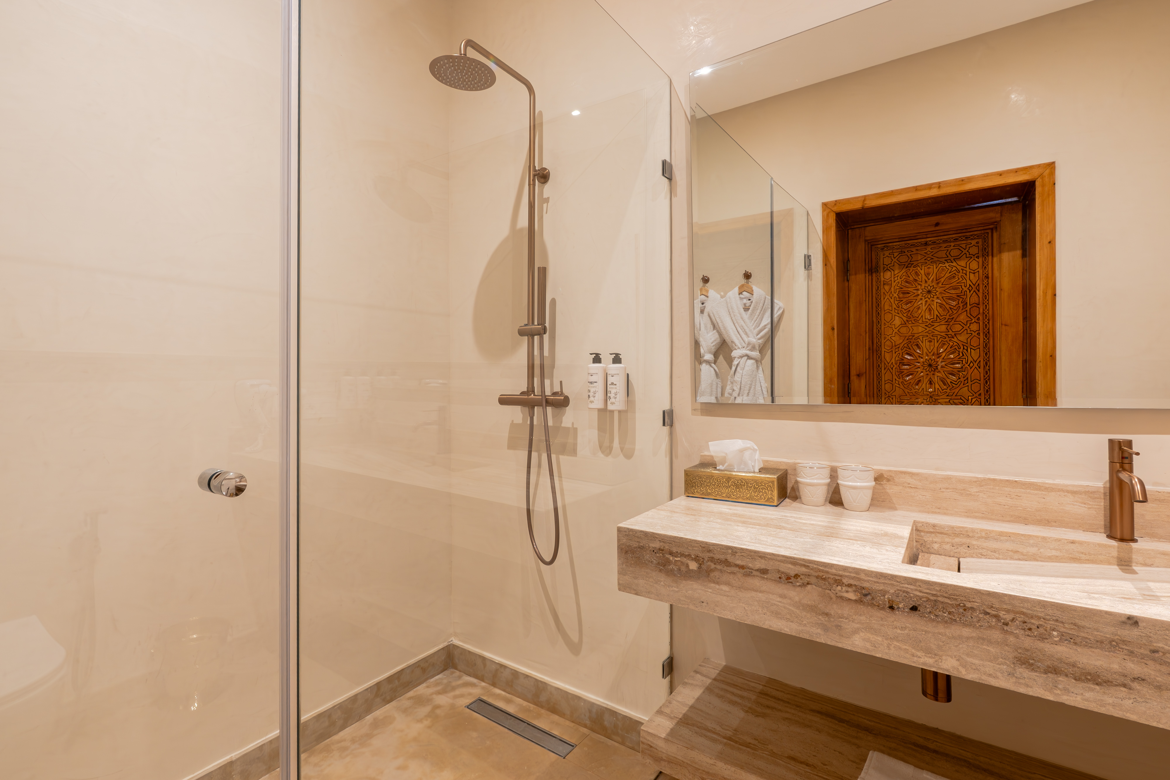 Suite bathroom with carved arch door