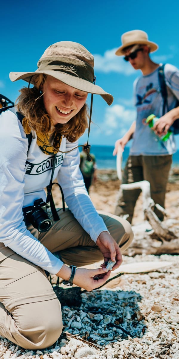 Students examine coral fragments on a rubble beach in Australia