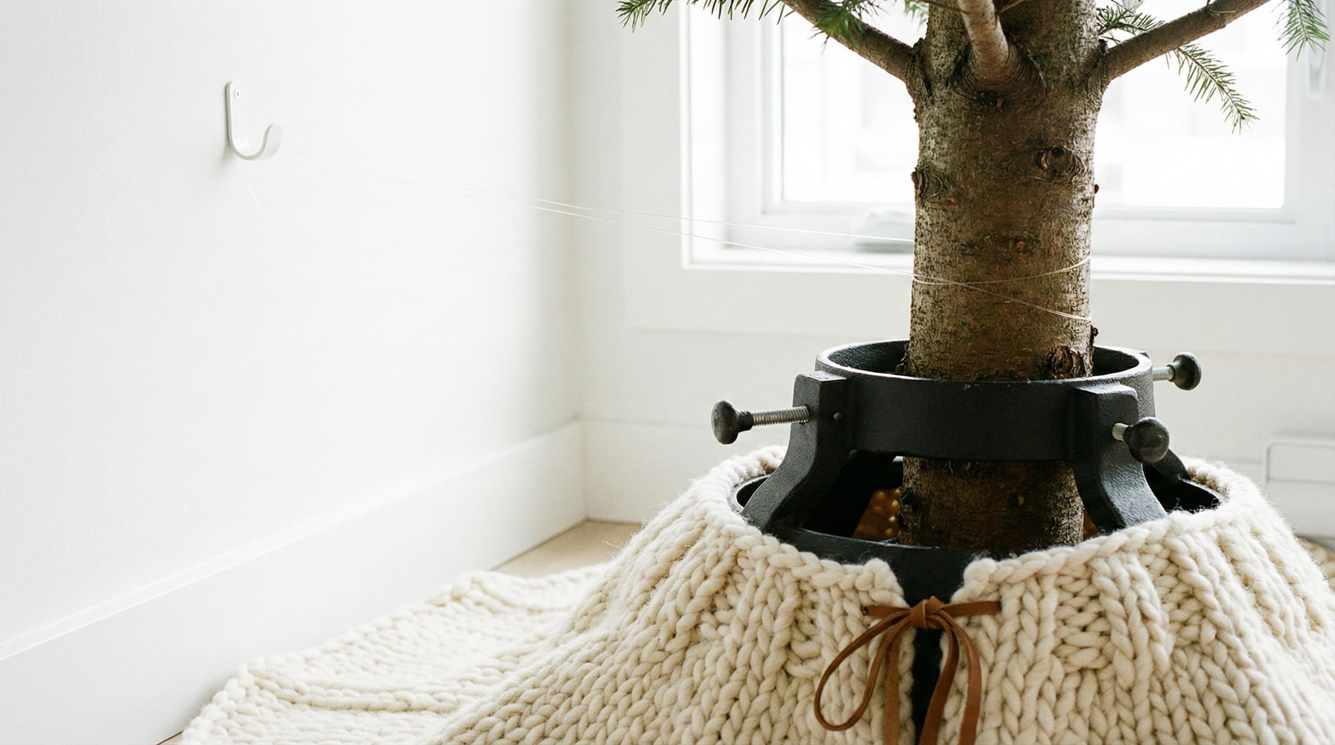 Detail of a Christmas tree secured to the wall to prevent falling