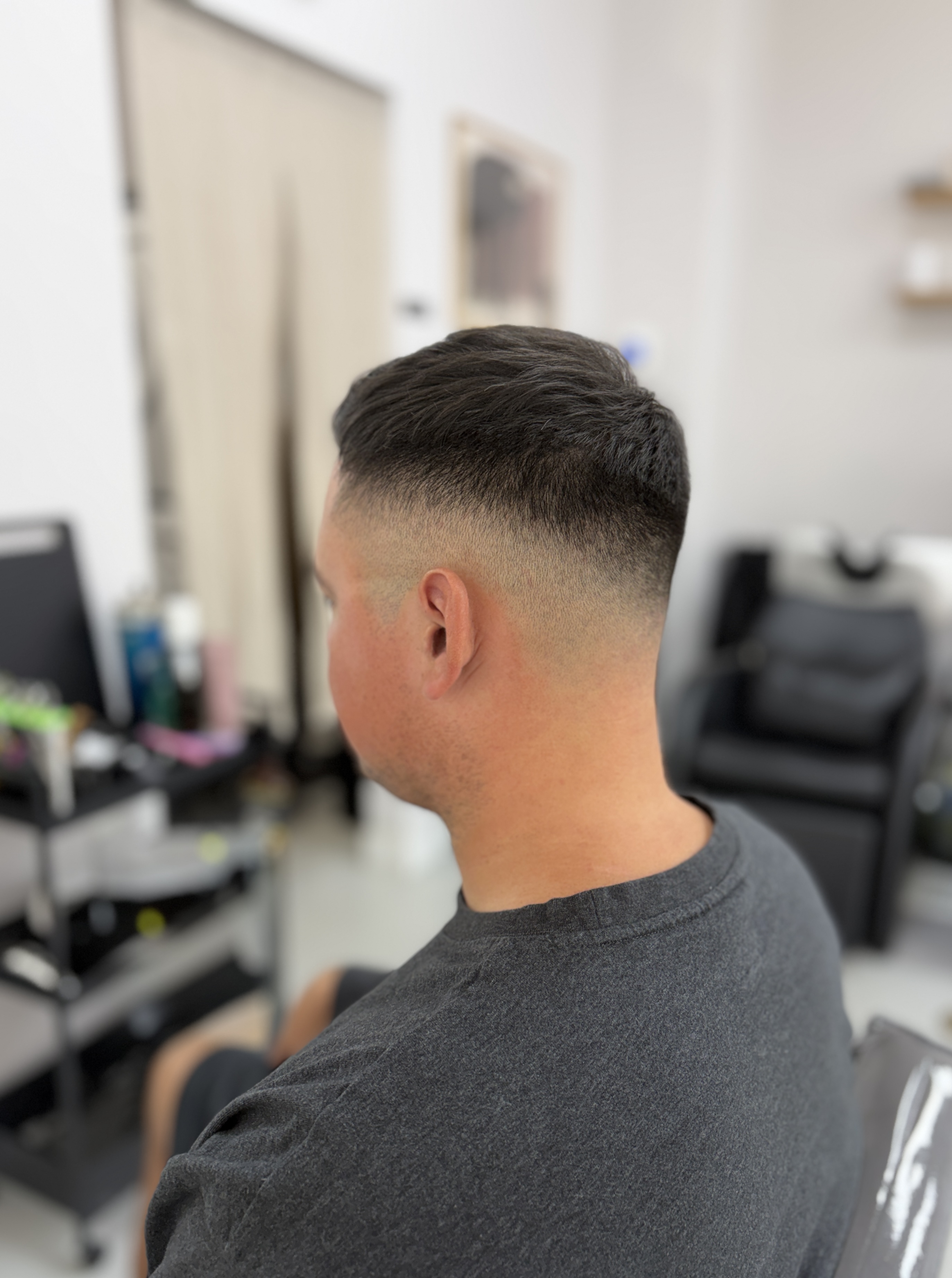 Rear-side view of a short haircut with closely faded sides and nape.