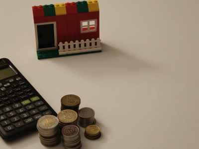 Lego House Coins and Calculator Home Financing Concept