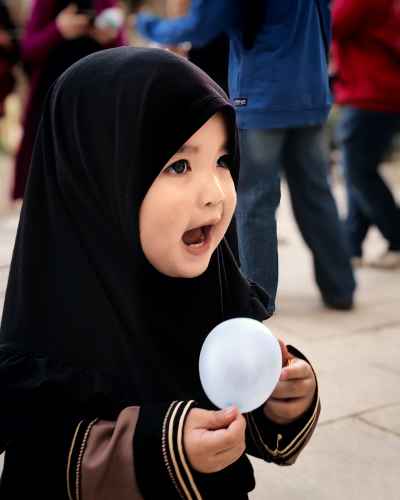 Young Girl Smiling in Sultan Hassan Mosque Courtyard, Cairo