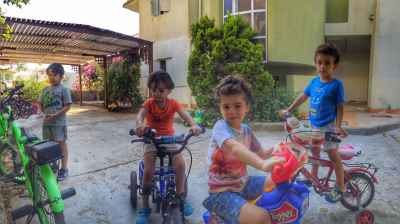 Boys Riding Bicycles and Tricycles Outdoors, Giza