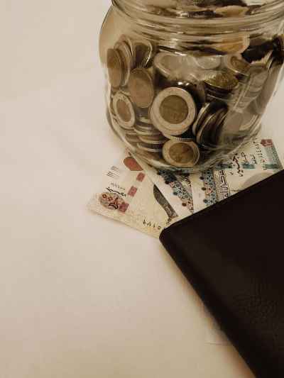 Egyptian Pounds Coins Jar and Banknotes with Wallet