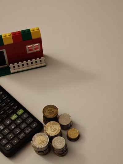 Real Estate Finance Concept with Coins and Calculator