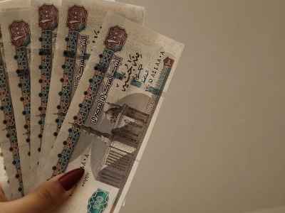 Egyptian Pound Banknotes Held in Hand