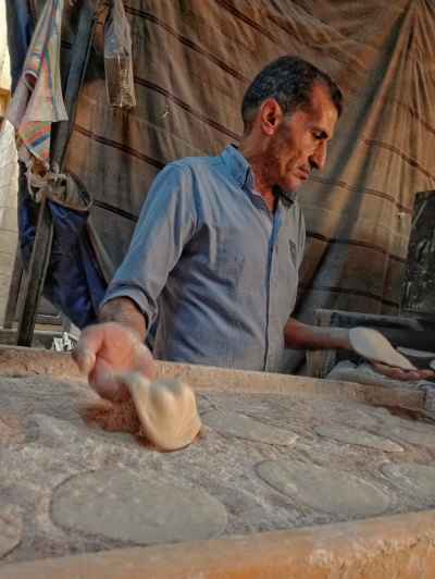 Egyptian Baker Making Fresh Baladi Bread in Al-Khayamiya Street
