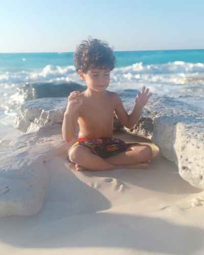 Boy in Meditation Pose on North Coast Beach, Egypt