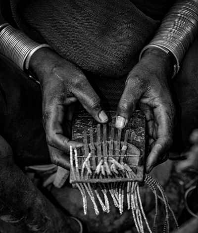 Suri Tribe Woman Playing Thumb Piano, Ethiopia