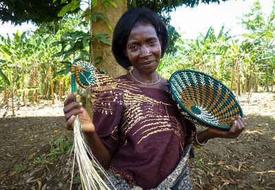 Ugandan Woman Displaying Handwoven Baskets, Uganda