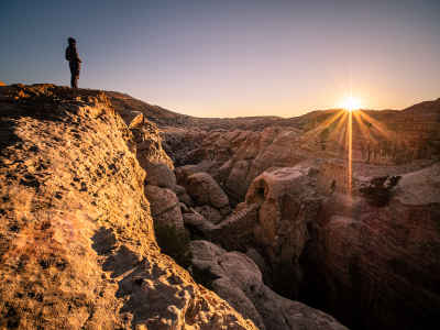 Hiker Silhouette at Sunset Over Petra Rocky Landscape