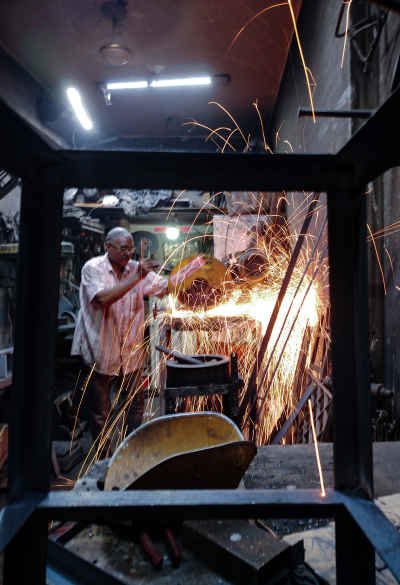 Egyptian Blacksmith Creating Sparks in the Streets of Old Cairo