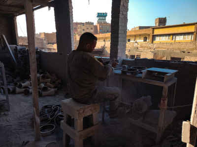 Egyptian Drum Maker Stretching Tabla Skin in a Traditional Workshop