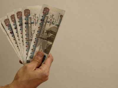 Hand Holding Egyptian Pound Banknotes Fan