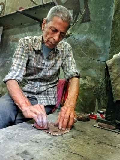 Traditional Coin Maker Crafting Handmade Metal Coins in Al-Muizz Street