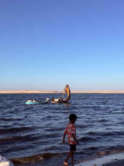 Child and Fishing Boats on Lake Timsah Shore, Ismailia