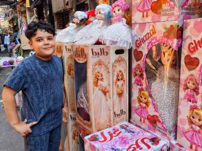 Boy Smiling Next to Moulid Doll Boxes, Sayeda Zeinab