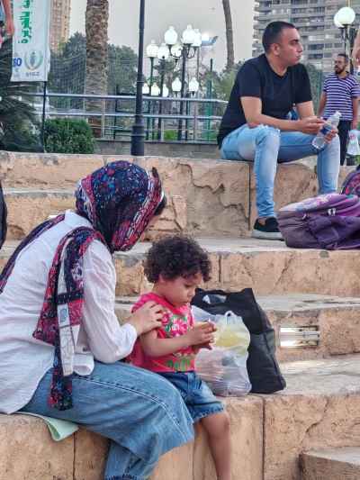 Mother and Child Share a Sandwich Before the World Cup Match at Gezira Youth Center