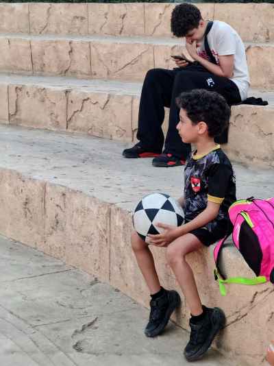 Egyptian Boy Holding Soccer Ball on Stone Steps