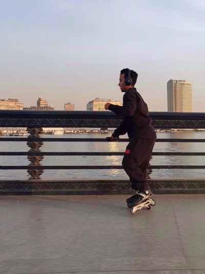 Young Man Inline Skating on Qasr El Nil Bridge Cairo