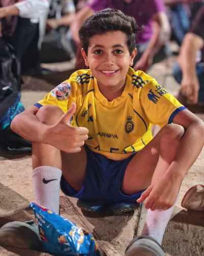 Happy Egyptian Boy Thumbs Up in Al-Nassr Jersey