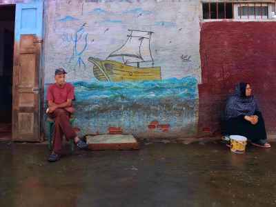 Man and Woman Seated by Ship Mural, Ezbet El Borg Fish Market