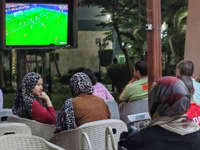 Egyptian Women Watching Football Match at Outdoor Café