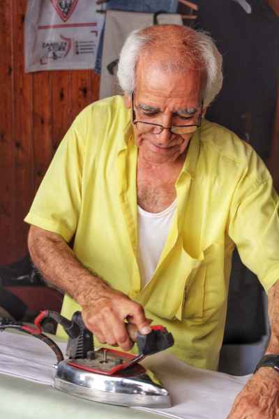 Elderly Craftsman Ironing Clothes, Traditional Workshop Alexandria