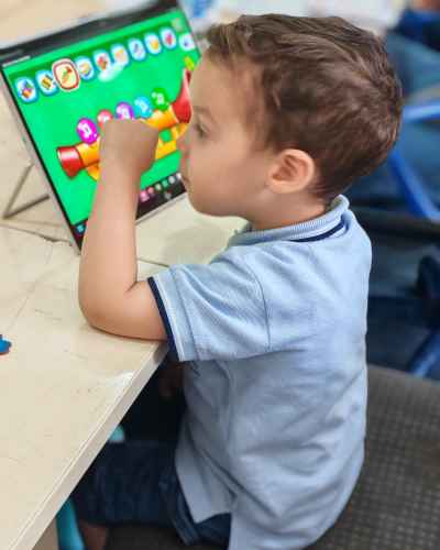 Young Child Using Educational App on Tablet