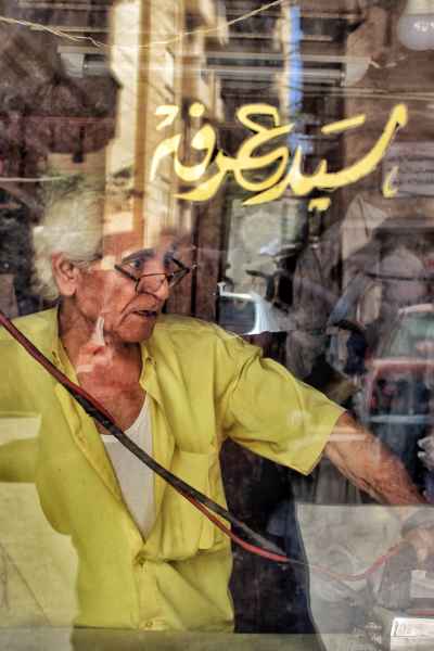 Tailor Sayed Arafa Ironing Behind Shop Window, Alexandria
