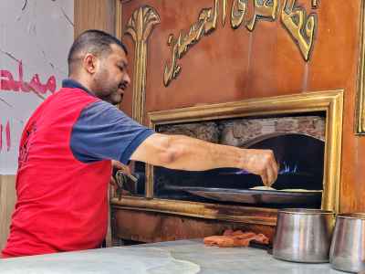 Baker Loading Baladi Bread Oven, Al-Hussein Cairo