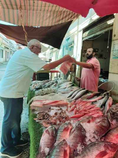 Fish Vendor and Buyer at Sayeda Fish Market Cairo