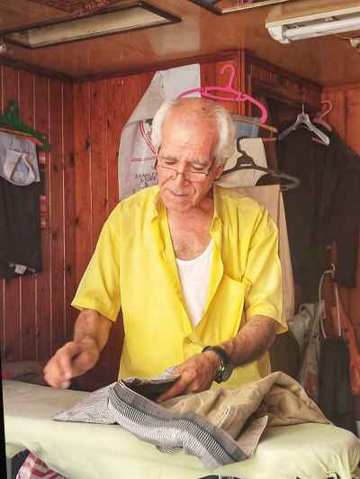 Laundry Worker Preparing Trousers for Ironing, Alexandria