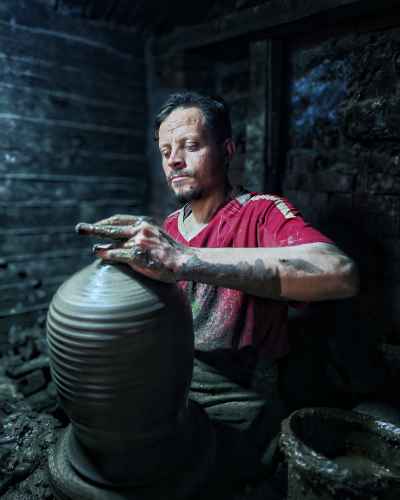 Egyptian Potter Shaping Clay on a Traditional Pottery Wheel