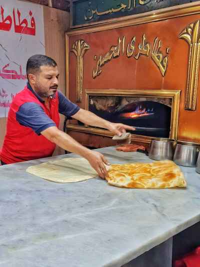 Baker Pulling Hot Feteer From Wood Oven, Al-Hussein Cairo