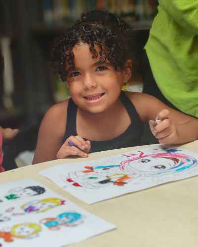 Girl Smiling While Coloring at Maktabet Masr El Gedida