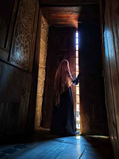 Muslim Woman Opening Wooden Window, Sultan Qalawoon Complex Cairo