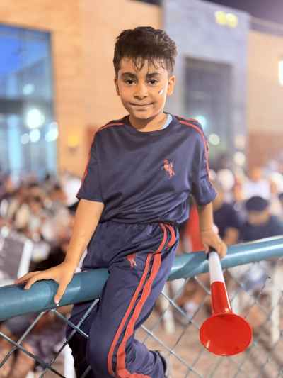 Egyptian Boy Fan Cheering at Night Football Match