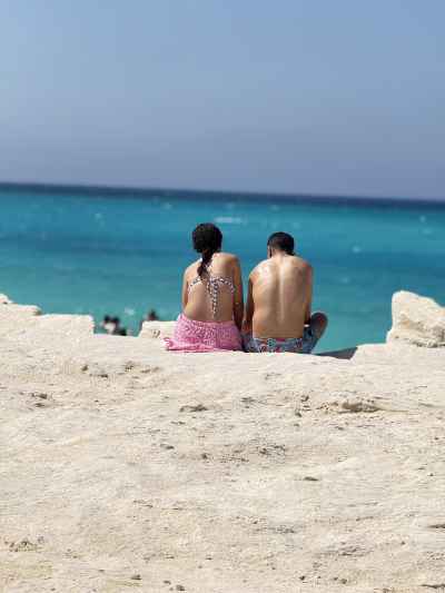 Couple Sitting on the Beach Facing the Mediterranean Sea at Egypt's North Coast