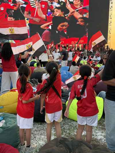 Egyptian Children Cheering at Football Fan Zone Screen