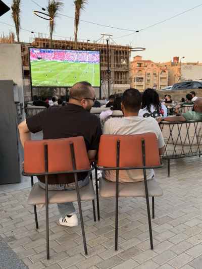 Friends Watching a Football Match at a Café