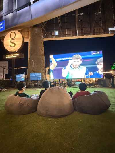 Friends Watching Football on a Big Screen at a Local Café